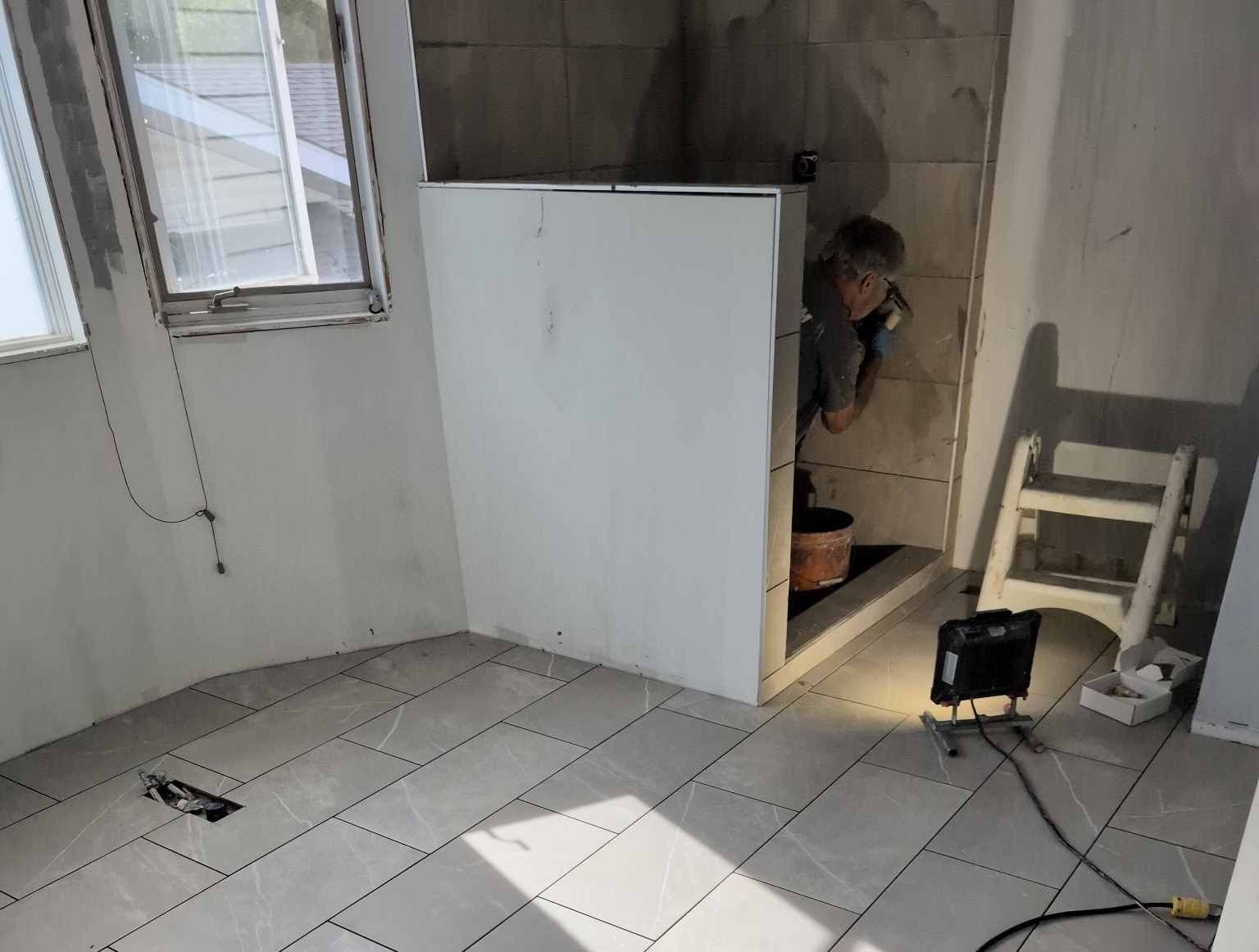 Tile flooring installation — Antrim Construction basement restoration project