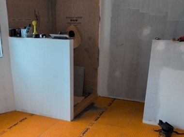 Completed bathroom renovation with white fixtures — Antrim Construction